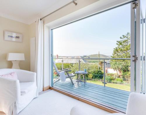 a living room with a large sliding glass door at Ragleighs in Polzeath