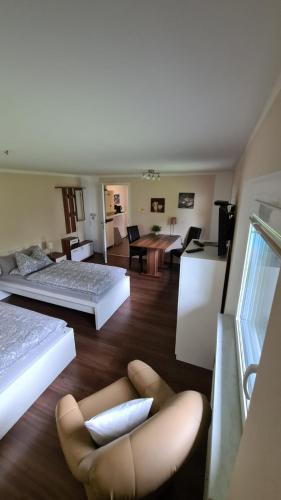 a living room with two beds and a chair at Monteurzimmer Senzig in Königs Wusterhausen