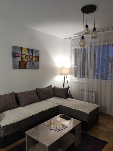 a living room with a couch and a coffee table at Apartman M in Požarevac