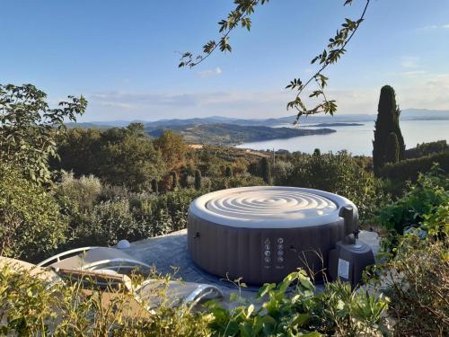 a large disk sitting on a hill with a view of the ocean at Villa La Moraiola in Passignano sul Trasimeno