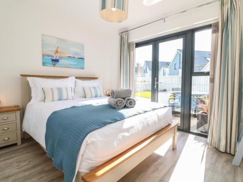 Un dormitorio con una cama grande y una ventana grande. en Seaquel, en Bideford