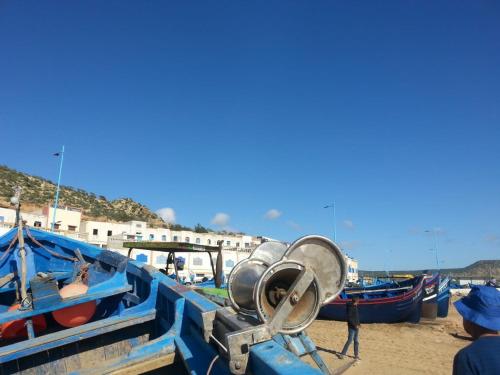 a group of blue boats parked on the beach at Aziki in Essaouira