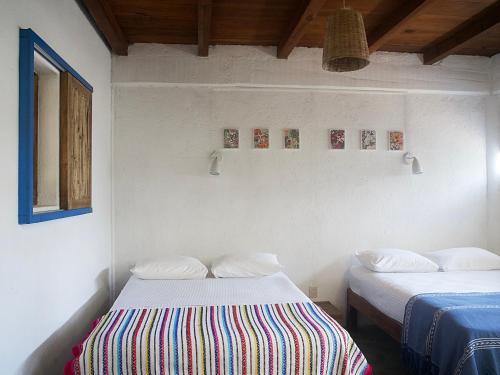 a room with two beds in a room at Una Posada Mas in Mazunte