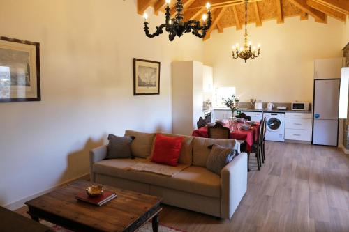 a living room with a couch and a table at Aldeia da Quinta do Paço - Turismo rural Santo Tirso in Santo Tirso