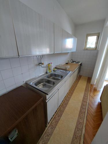 a kitchen with a sink and a counter top at Hills Apartment in Niš