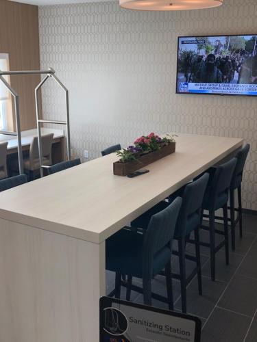 a conference room with a table with chairs and a tv at Microtel Inn & Suites by Wyndham Carlisle in Carlisle