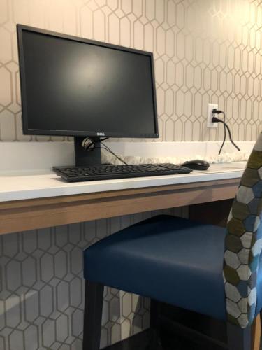 a computer monitor sitting on top of a desk at Microtel Inn & Suites by Wyndham Carlisle in Carlisle