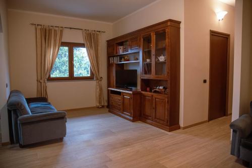 a living room with a entertainment center and a television at B&b Villa Sofia in Fara Novarese