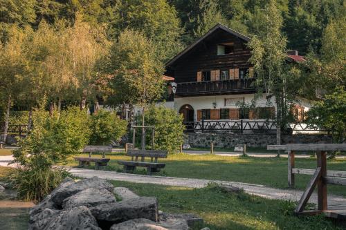 a building with benches in front of a park at Hotel Restaurant Alatsee in Füssen