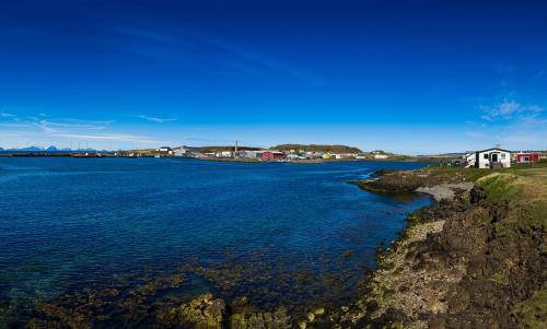 a large body of water with houses on the shore at Salthús Guesthouse in Skagaströnd