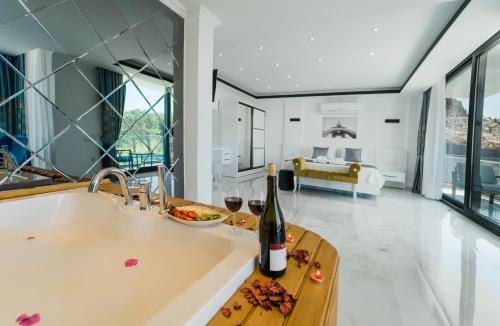 a kitchen with a sink and a bottle of wine at Villa Alva Donna Exclusive - Patara in Kas
