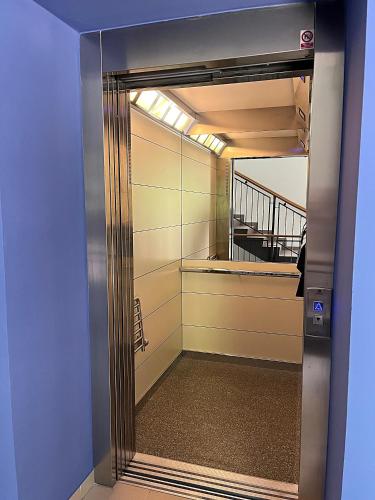 an elevator door with a view of a staircase at Apartmán HYGGE Bratrouchov in Jablonec nad Jizerou