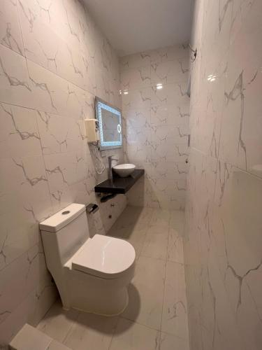a bathroom with a toilet and a tv on the wall at Casona Plaza Hotel Cusco in Cusco