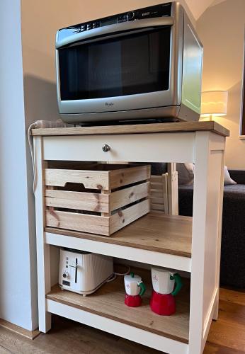 a tv on a white table with a tv on it at Apartmán HYGGE Bratrouchov in Jablonec nad Jizerou