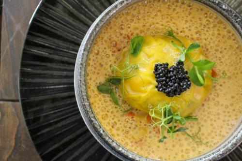 a bowl of soup with a blackberry on top at Moulin de Fourges in Fourges