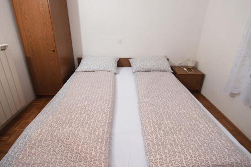 a bed in a room with two mattresses at Roja House in Soča