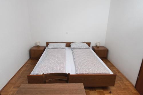 a twin bed in a room with two chairs at Roja House in Soča