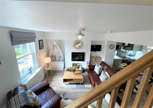 a living room with a couch and a table at Coorie Doon in Cairnbaan