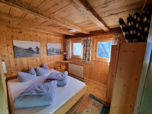a room with couches in a wooden house at Almhütte Chrisanten Thaya Sölden in Sölden