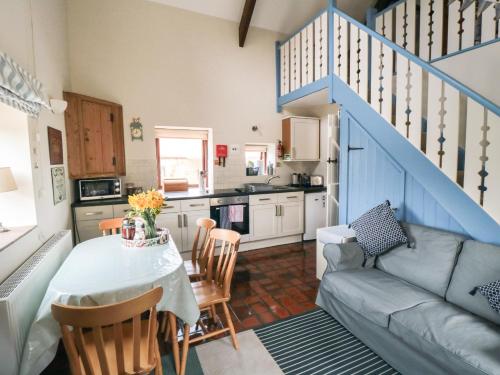 a kitchen and living room with a table and a couch at Farndale in Whitby