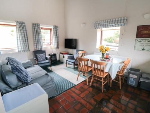 a living room with a table and a couch at Farndale in Whitby