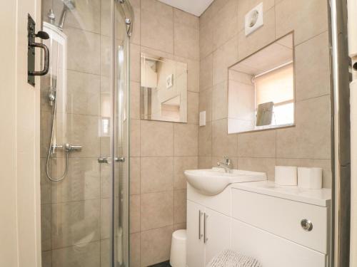 a bathroom with a shower and a sink and a toilet at Glaisdale in Whitby