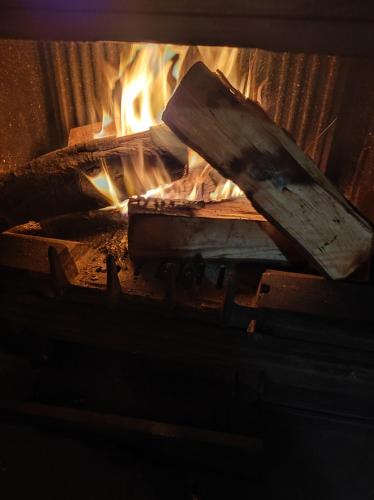 a fire in a brick oven with some wood at Villa Alejandra in Cudillero