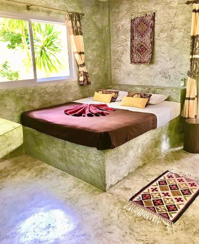 a bedroom with a large bed in a room at New Moon in Thongsala