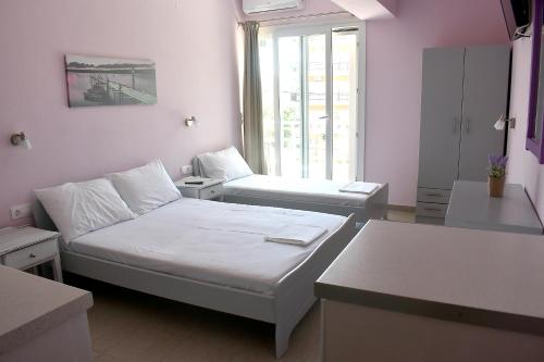 a small room with a bed and a table at Giorgos-Fenia Apartments in Paralia Katerinis