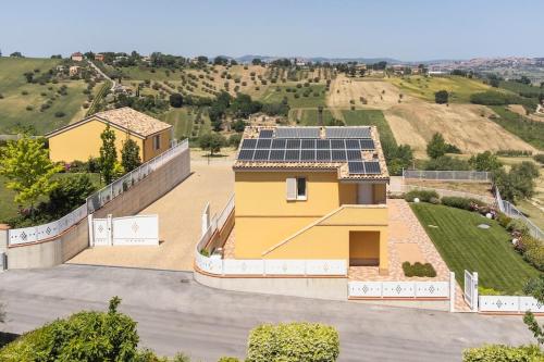 a house with solar panels on top of it at Sul Calar del Sole al Conero in Recanati