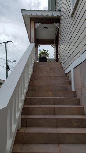 a set of stairs leading to a house at One South Place Hotel in Belize City