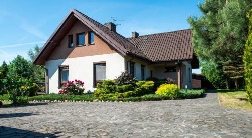 a house with a driveway in front of it at Charming place - Kraków Gdów Jacuzzi in Gdów