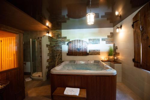 a large bathroom with a tub and a shower at Charming place - Kraków Gdów Jacuzzi in Gdów