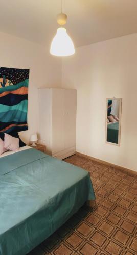 a bedroom with a bed and a white cabinet at Nicolai63 in Bari