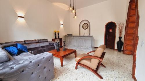 a living room with a couch and a table at Hotel Karlo By GHO Hoteles in Cali