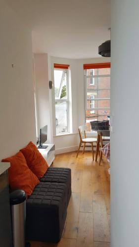 a living room with a couch and a table at The Little Flat on the Corner in Cromer