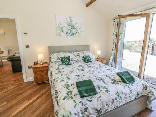 a bedroom with a bed and a large window at Fairfield in Ludlow