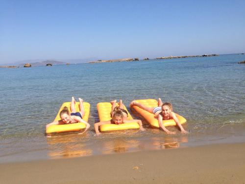 people sitting on surfboards in the water at Candia Hotel in Chania