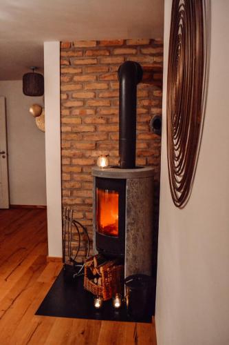 a fireplace in a room with a brick wall at Damwildfarm in Rollerbü Südschweden in Tyringe