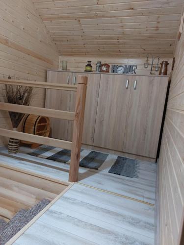 a sauna with wooden cabinets in a cabin at Cabana Rustica Georgeta in Zărneşti