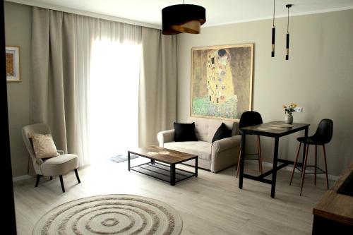 a living room with a couch and a table at Capitals Residence in Oświęcim
