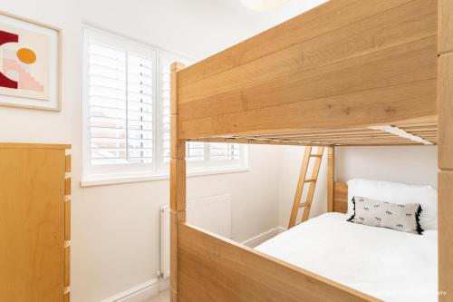 a bedroom with a bunk bed and a window at 6 Woodville in The Mumbles