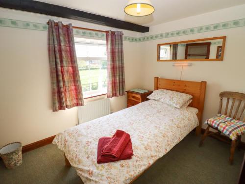 1 dormitorio con 1 cama, 1 silla y 1 ventana en The Vinery, en Gloucester