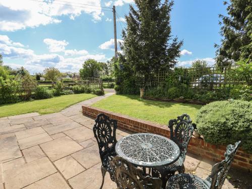 a patio with a table and two chairs at The Vinery in Gloucester