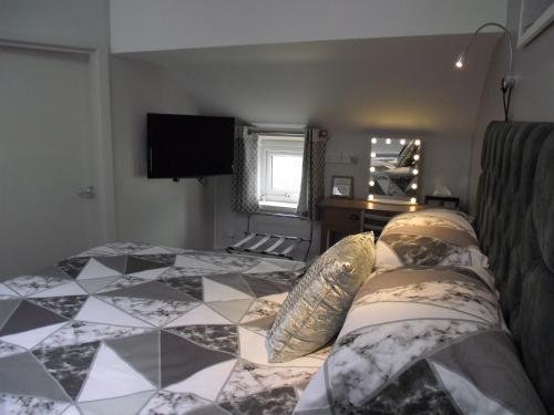 a bedroom with a bed with pillows on it at Seahawk Holiday Apartments in Cleveleys