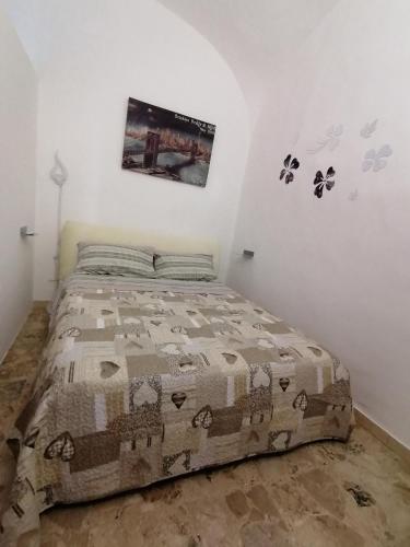 a bedroom with a bed with a blanket on it at Casa sul mare in Procida