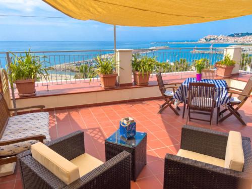 a patio with chairs and a table with a view of the ocean at Vista Mare Borgo Peri in Imperia