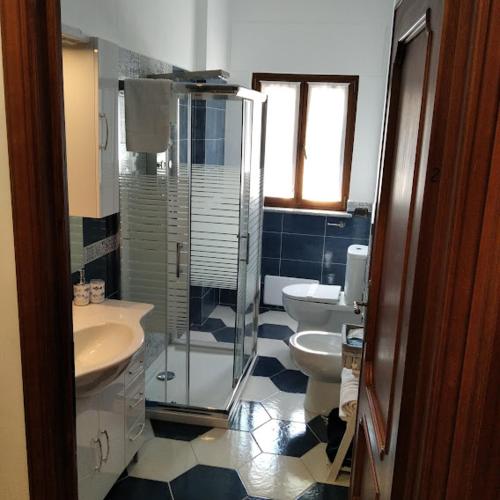 a bathroom with two toilets and a glass shower at B&b Villa Sofia in Fara Novarese