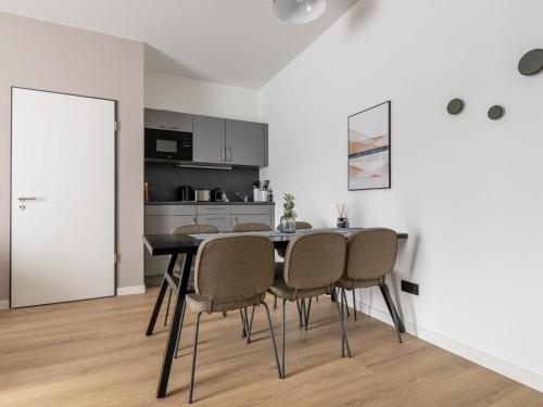 a dining room with a black table and chairs at Limehome Bodenmais Bahnhofstraße in Bodenmais