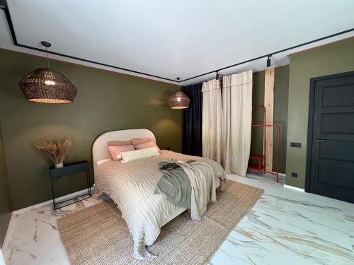 a bedroom with a bed in a room with green walls at Cozy beach house Jurmala II in Jūrmala